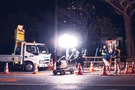 LED balloon light tower illuminates a road maintenance work.